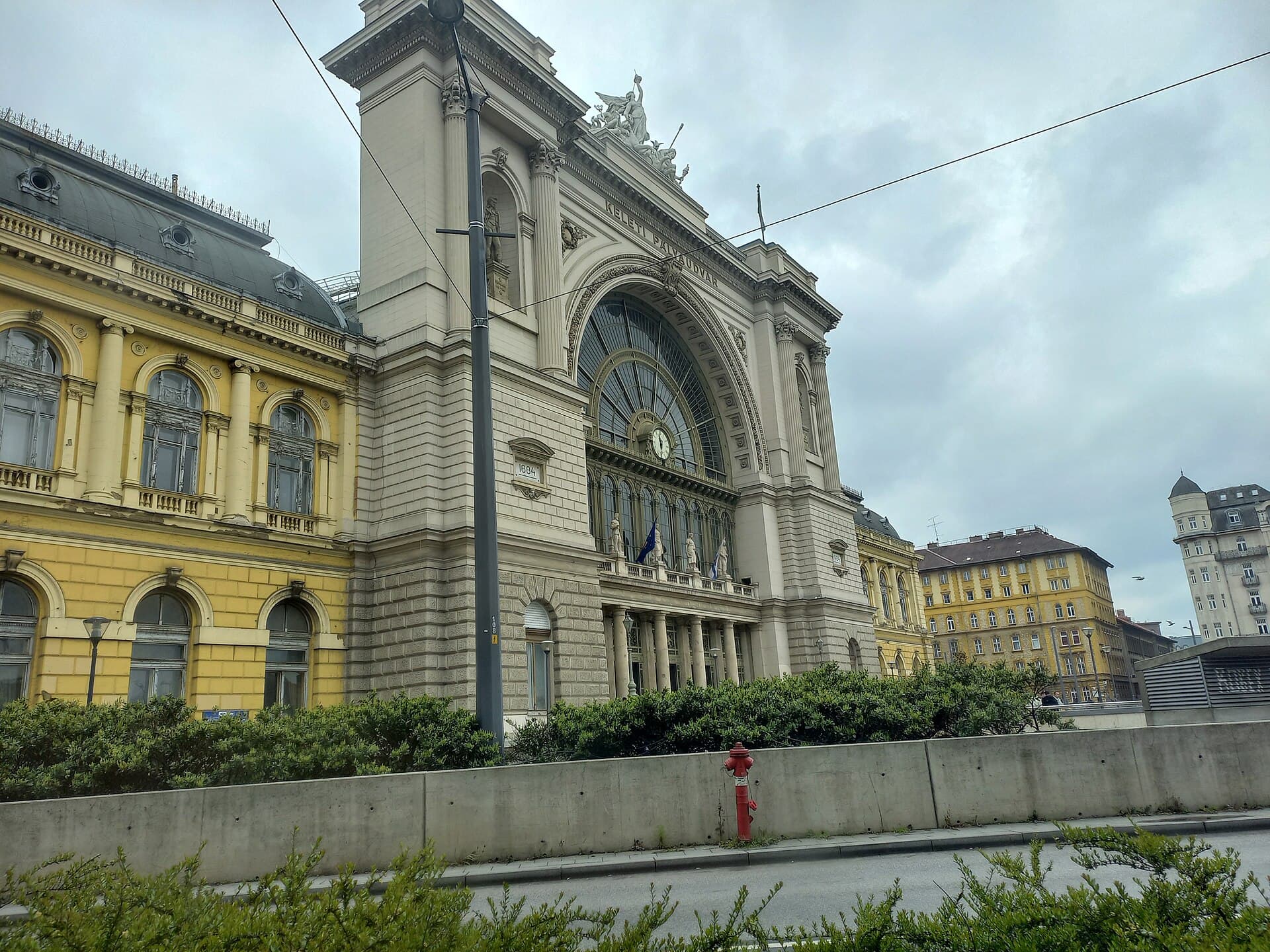 The main facade of Budapest Keleti railway station, with the words Keleti Palyaudvar carved above the great arched window