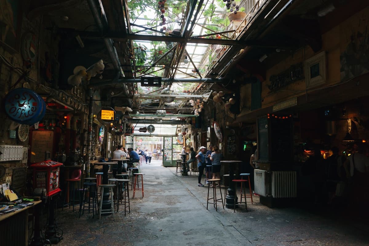 The courtyard of a Budapest ruin bar at night, lit with string lights